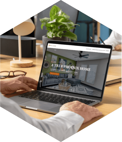 Hands on a laptop showing a Swifty apartment website with the headline A True Phoenix Home